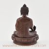 Back view of Medicine Buddha Figurine with detailed ornamental patterns.