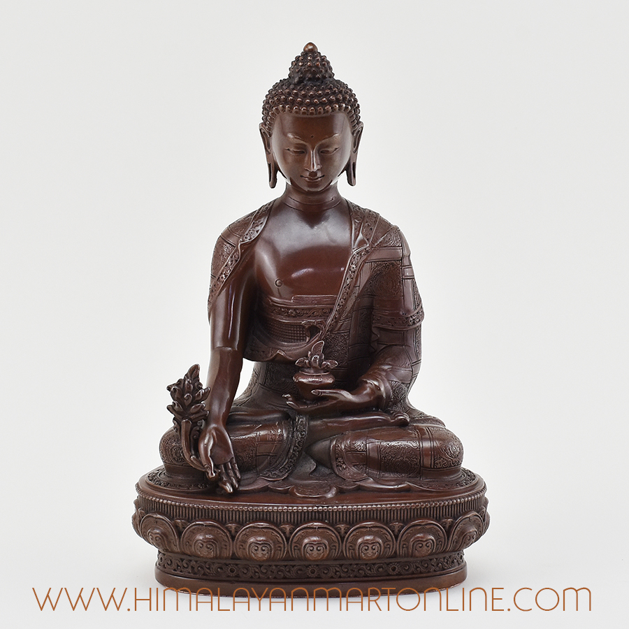 Front view of handcrafted Medicine Buddha Figurine in oxidized copper.