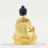 Back of Tibetan Medicine Buddha sculpture showcasing detailed carvings and gold-plated finish.