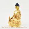 Left side of Tibetan Medicine Buddha sculpture with gold plating and detailed engravings.