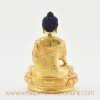 Back of Tibetan Shakyamuni Buddha sculpture showcasing detailed gold-plated carvings.