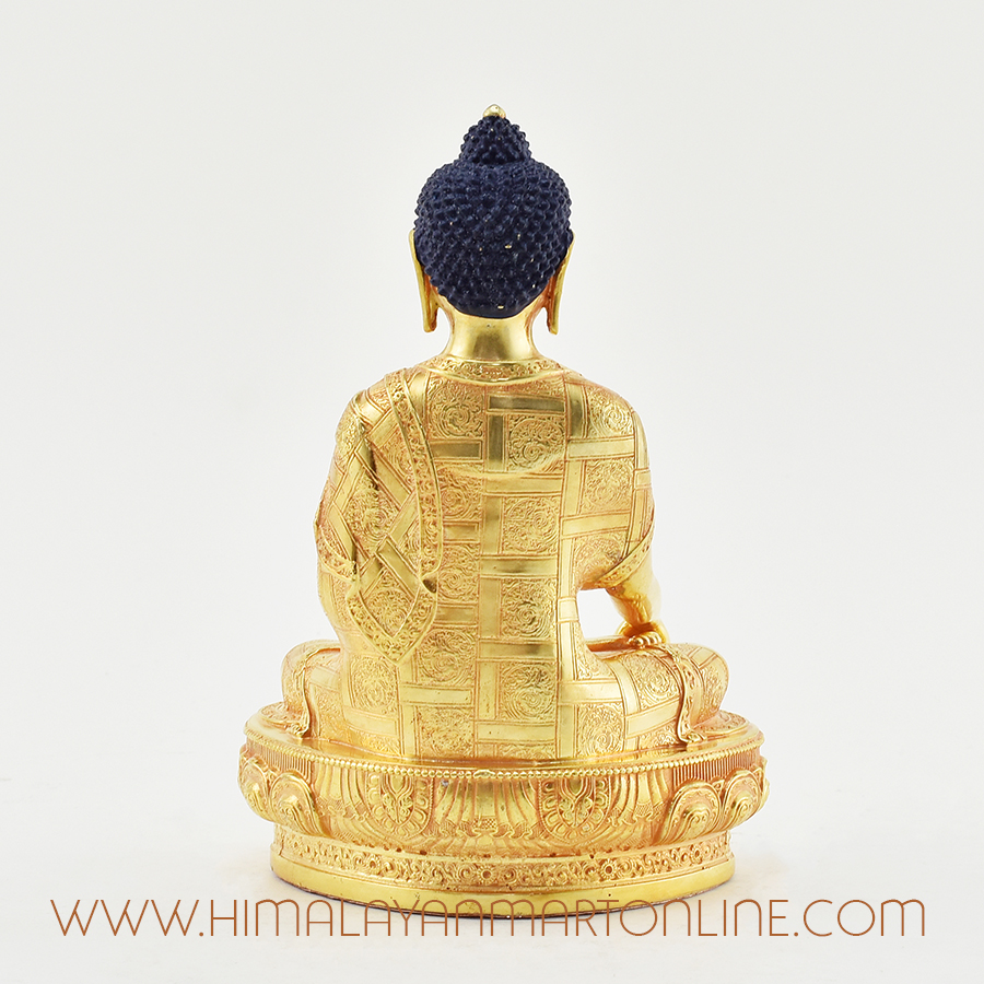 Back of Tibetan Shakyamuni Buddha sculpture showcasing detailed gold-plated carvings.