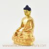 Left side of Tibetan Shakyamuni Buddha sculpture with gold plating and detailed engravings.