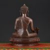 Back view of Medicine Buddha Idol handcrafted in Nepal showing detailed carving and traditional finish.