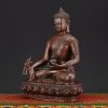 Left view of Medicine Buddha Idol handmade in Nepal with lotus base and meditative posture.